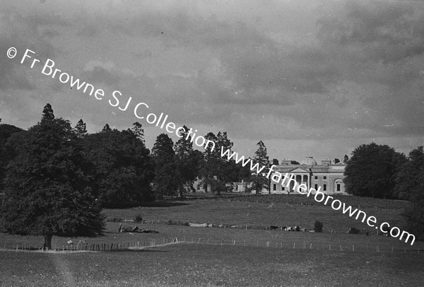 DISTANT VIEW OF HOUSE IN HARVEST TIME